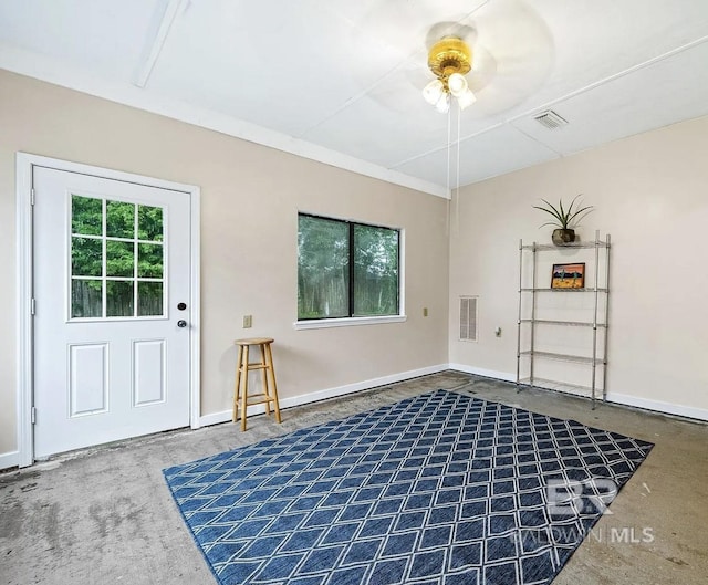 miscellaneous room with ceiling fan and concrete flooring