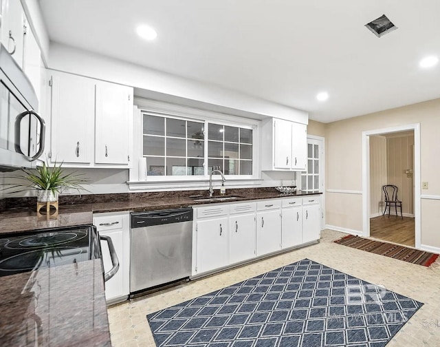 kitchen featuring stainless steel appliances, white cabinetry, and sink