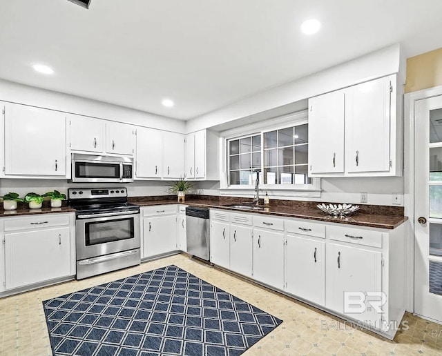 kitchen featuring white cabinets, appliances with stainless steel finishes, and sink