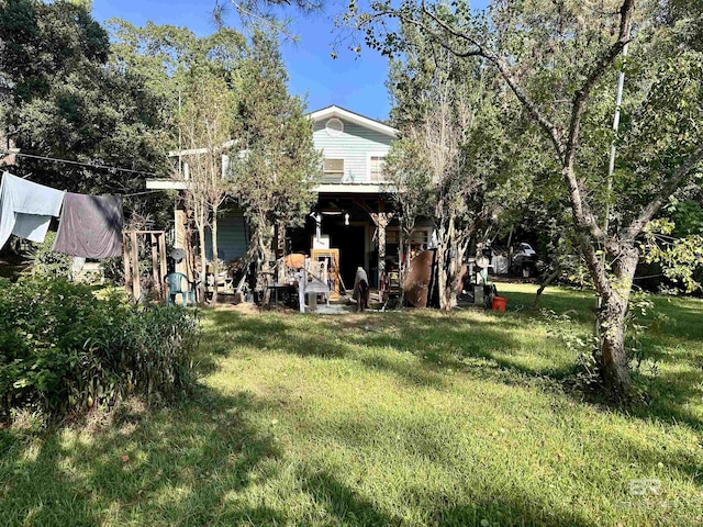 back of property featuring a lawn