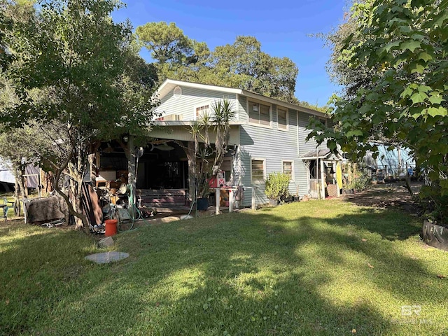 rear view of house featuring a lawn