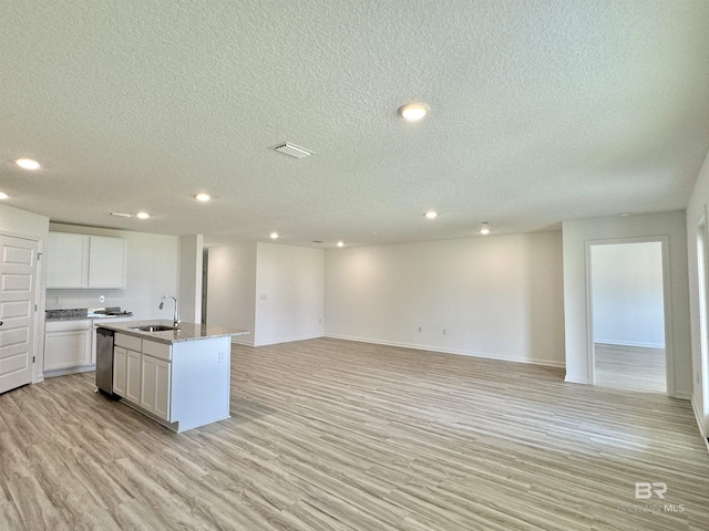 1036 Hayward Loop, Foley, AL 36535 - kitchen featuring a sink, recessed lighting, a textured ceiling, open floor plan, and light wood-style flooring