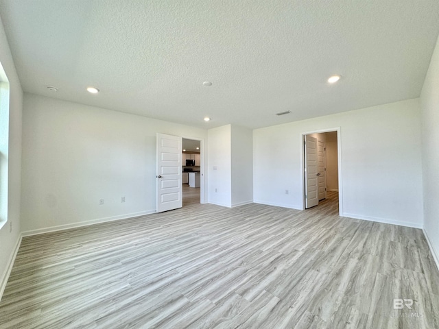 1036 Hayward Loop, Foley, AL 36535 - unfurnished bedroom with light wood-type flooring, recessed lighting, baseboards, and a textured ceiling