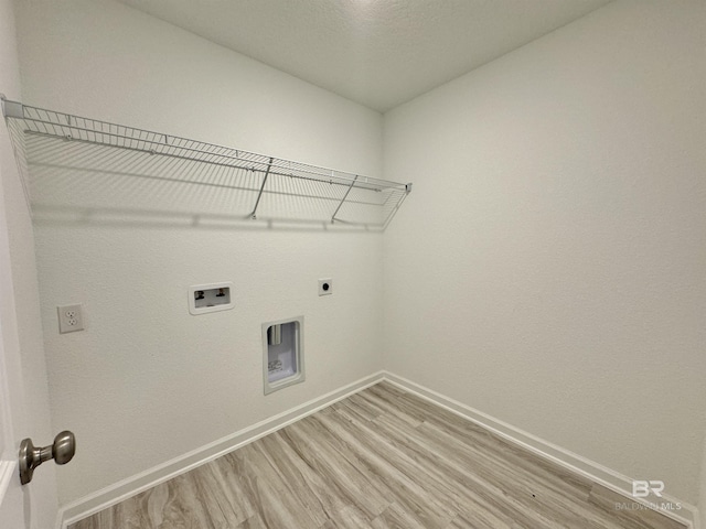 1036 Hayward Loop, Foley, AL 36535 - laundry area featuring light wood finished floors, baseboards, washer hookup, and hookup for an electric dryer