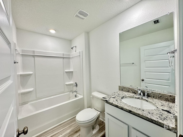 1036 Hayward Loop, Foley, AL 36535 - full bath featuring vanity, wood finished floors, tub / shower combination, toilet, and a textured ceiling