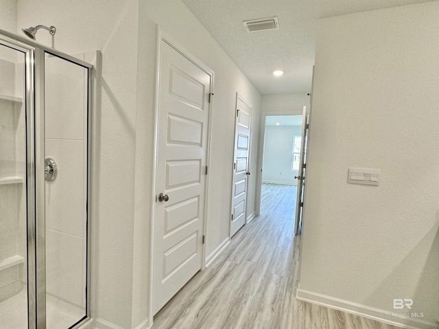 1036 Hayward Loop, Foley, AL 36535 - bathroom featuring wood finished floors, a stall shower, and baseboards