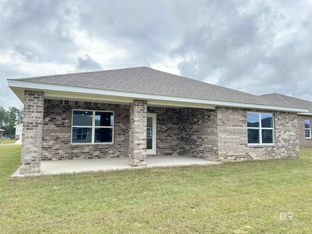 1036 Hayward Loop, Foley, AL 36535 - back of property featuring brick siding, roof with shingles, and a yard