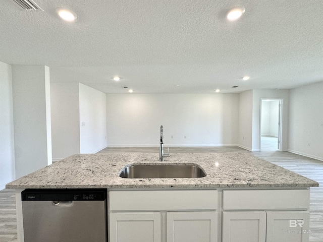 1036 Hayward Loop, Foley, AL 36535 - kitchen with dishwasher, a sink, open floor plan, light wood-type flooring, and white cabinets
