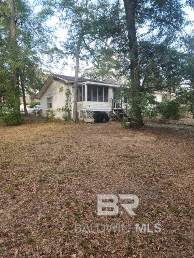 view of front of house featuring a sunroom