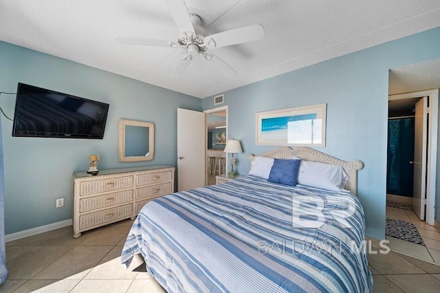 bedroom featuring light tile patterned flooring, a textured ceiling, and ceiling fan