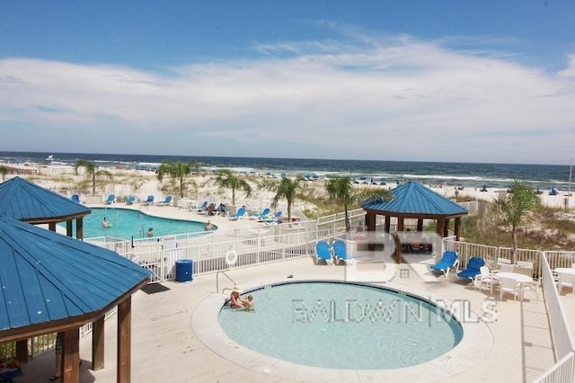 view of swimming pool with a patio, a gazebo, and a water view