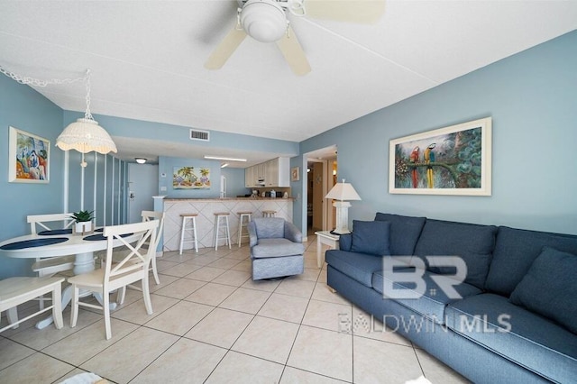 living room featuring ceiling fan and light tile patterned floors