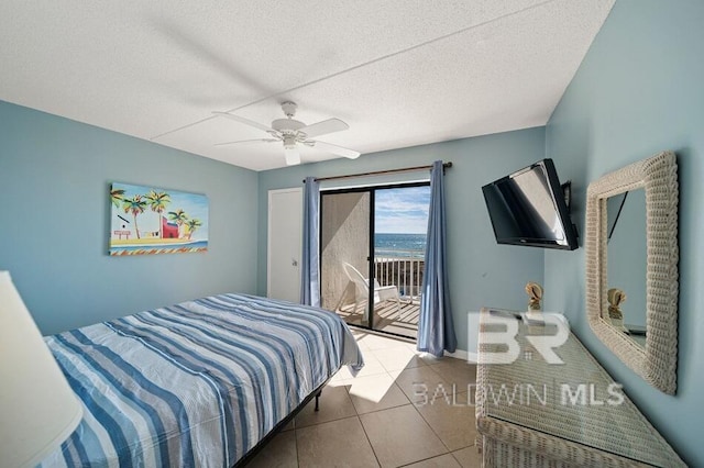 bedroom with tile patterned floors, a textured ceiling, ceiling fan, and access to exterior