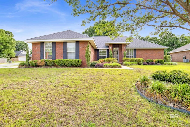 ranch-style home with brick siding, a front yard, a detached garage, and central air condition unit