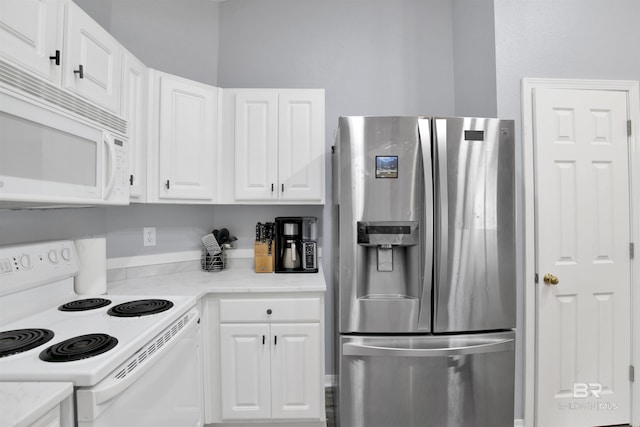 kitchen with white appliances, white cabinets, and light stone counters