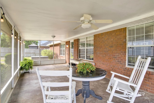 unfurnished sunroom featuring a ceiling fan