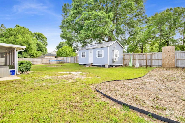 view of yard featuring entry steps, a trampoline, and an outbuilding