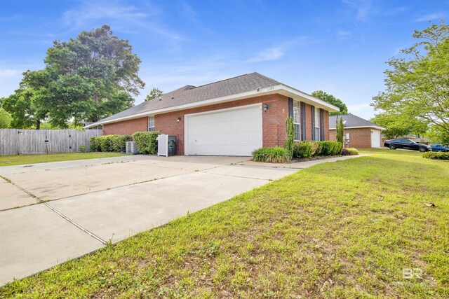 view of side of home with brick siding, an attached garage, and driveway