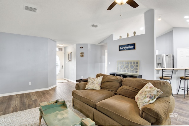 living area featuring ceiling fan, light wood-style floors, lofted ceiling, and baseboards