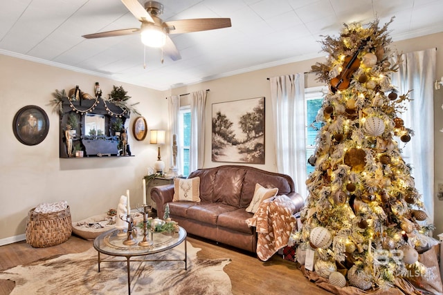 living room featuring crown molding, light hardwood / wood-style floors, and ceiling fan