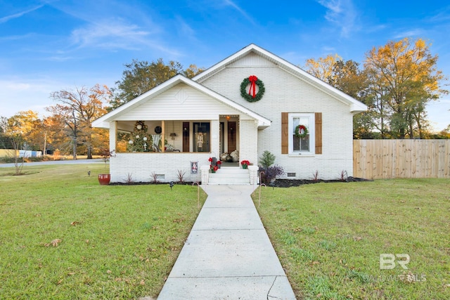 bungalow-style home with a front lawn and covered porch