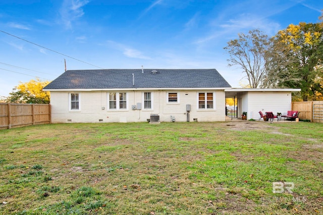 rear view of house featuring a patio, a yard, and central AC unit