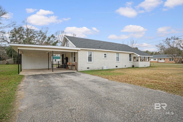 view of front of home with a front yard and a carport