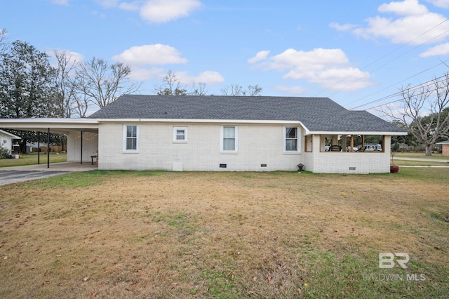 exterior space featuring a carport and a lawn