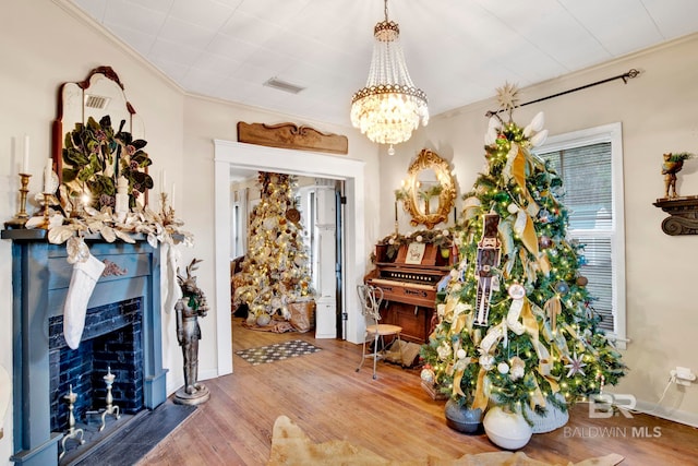 interior space with hardwood / wood-style flooring, crown molding, and a notable chandelier