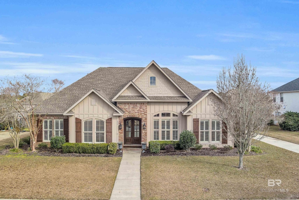 view of front facade with french doors and a front lawn