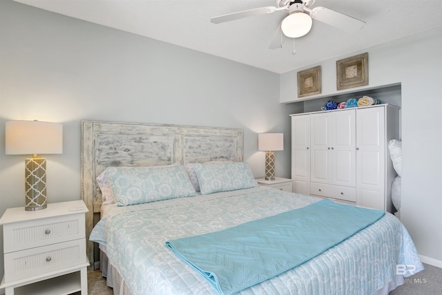 bedroom with a ceiling fan, carpet, and a closet