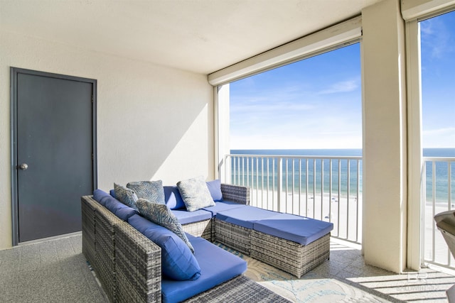 balcony featuring a beach view, outdoor lounge area, and a water view