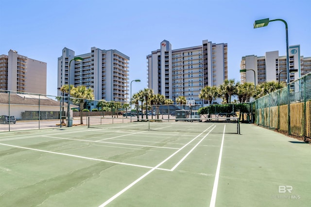 view of tennis court with fence