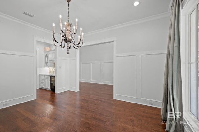 202 Paddle Creek Loop, Fairhope, AL 36532 - unfurnished dining area featuring a decorative wall, a chandelier, crown molding, plenty of natural light, and dark wood finished floors