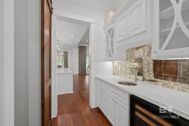 202 Paddle Creek Loop, Fairhope, AL 36532 - indoor wet bar with wine cooler, dark wood finished floors, crown molding, backsplash, and recessed lighting