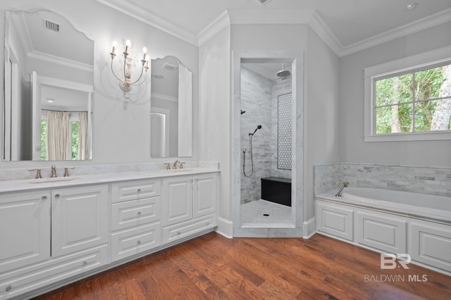 202 Paddle Creek Loop, Fairhope, AL 36532 - bathroom featuring tiled shower, a bath, wood finished floors, double vanity, and crown molding