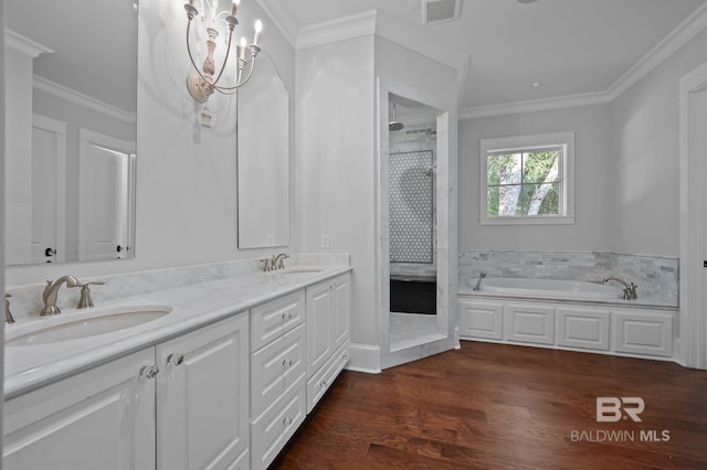 202 Paddle Creek Loop, Fairhope, AL 36532 - bathroom with a stall shower, double vanity, a garden tub, wood finished floors, and ornamental molding