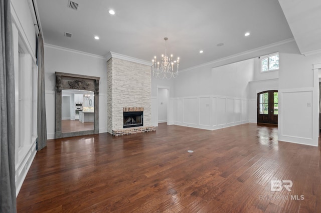 202 Paddle Creek Loop, Fairhope, AL 36532 - unfurnished living room featuring a chandelier, a fireplace, wood finished floors, crown molding, and recessed lighting