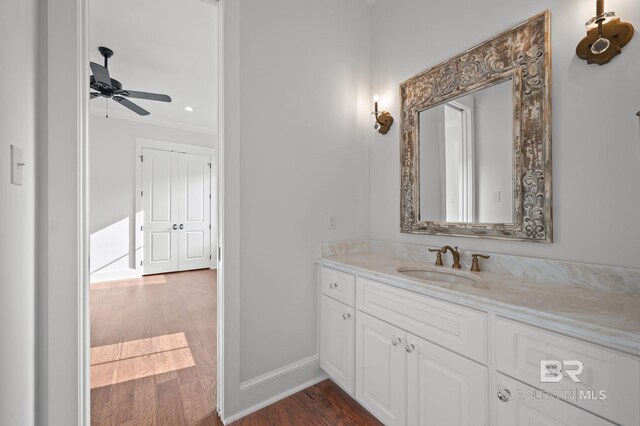 202 Paddle Creek Loop, Fairhope, AL 36532 - bathroom featuring wood finished floors, vanity, ceiling fan, baseboards, and crown molding