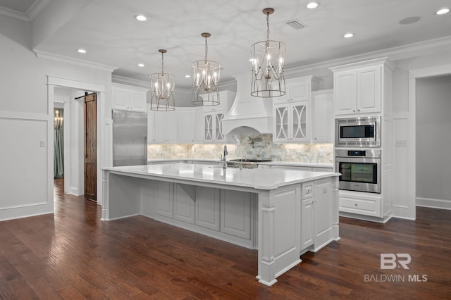 202 Paddle Creek Loop, Fairhope, AL 36532 - kitchen with stainless steel appliances, custom exhaust hood, glass insert cabinets, white cabinetry, and crown molding