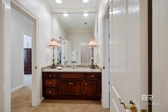 bathroom with crown molding and vanity