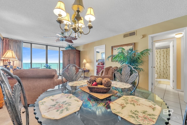 24522 Perdido Beach Blvd Unit 5617, Orange Beach, AL 36561 - tiled living room with a chandelier, a textured ceiling, and expansive windows