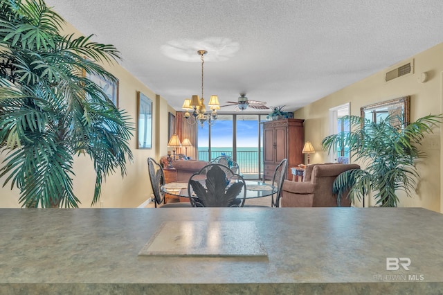 24522 Perdido Beach Blvd Unit 5617, Orange Beach, AL 36561 - dining room featuring a chandelier and a textured ceiling