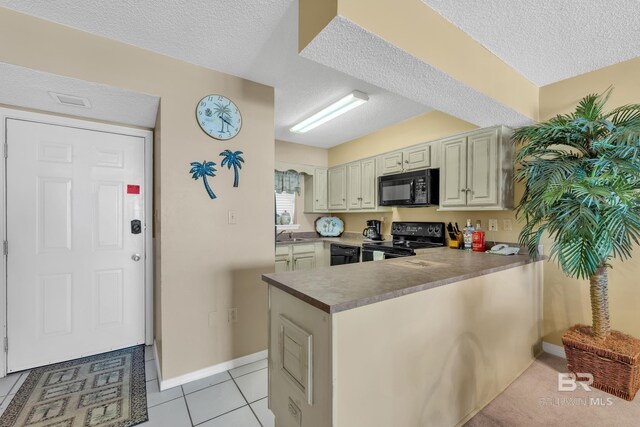 24522 Perdido Beach Blvd Unit 5617, Orange Beach, AL 36561 - kitchen with black appliances, a textured ceiling, a peninsula, and light tile patterned flooring