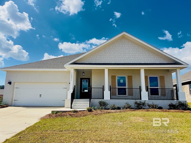view of front of property with driveway, a front lawn, covered porch, brick siding, and a garage