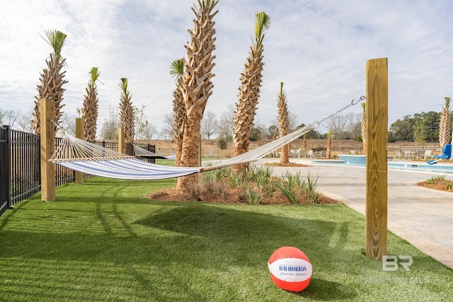 exterior space with a patio area, a lawn, and a pool