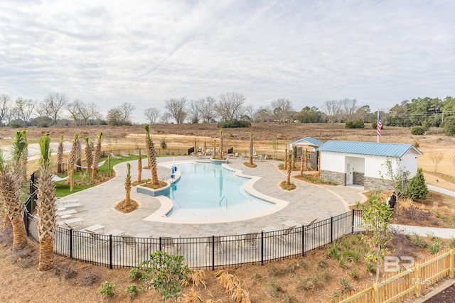 view of pool featuring a patio area and a rural view