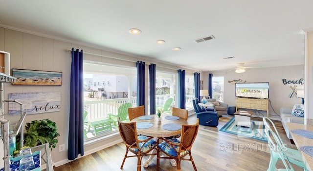 dining space featuring ceiling fan, crown molding, and light hardwood / wood-style flooring