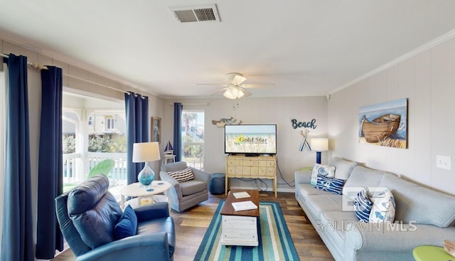 living room featuring ceiling fan, wood-type flooring, and crown molding