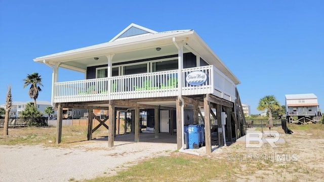 back of house featuring a carport